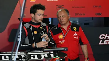 Ferrari's Monegasque driver Charles Leclerc (L) speaks with Ferrari's team principal Frederic