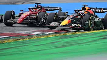 Ferrari's Monegasque driver Charles Leclerc (L) competes to win ahead of Red Bull Racing's Dutch