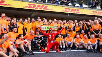 MEXICO CITY, MEXICO - OCTOBER 27: Carlos Sainz of Spain and Ferrari photobombs the McLaren