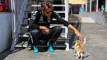 BAKU, AZERBAIJAN - SEPTEMBER 20: George Russell of Great Britain and Mercedes with a Baku cat in