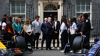 LONDON, ENGLAND - JULY 2: UK Prime Minister talks with Formula One team apprentices outside 10