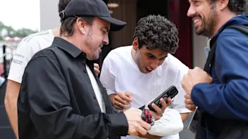 SPA, BELGIUM - JULY 16: Fernando Alonso of Spain and Aston Martin F1 Team shows something on his