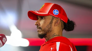ZANDVOORT, NETHERLANDS - AUGUST 23: Lewis Hamilton of Great Britain and Scuderia Ferrari answers