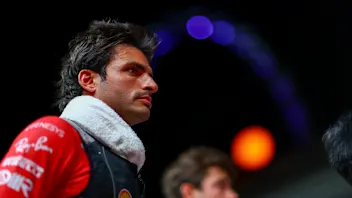 SINGAPORE, SINGAPORE - SEPTEMBER 17: Carlos Sainz of Spain and Ferrari looks on from the grid prior