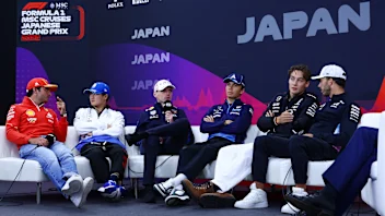 SUZUKA, JAPAN - APRIL 04: Carlos Sainz of Spain and Ferrari, Yuki Tsunoda of Japan and Visa Cash