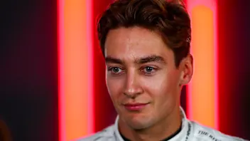 LUSAIL CITY, QATAR - NOVEMBER 30: George Russell of Mercedes and Great Britain talks to the press