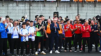 SHANGHAI, CHINA - MARCH 23: Drivers and team personnel gather for a tribute to the late Eddie