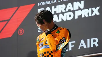 BAHRAIN, BAHRAIN - APRIL 13: Third placed Lando Norris of Great Britain and McLaren on the podium