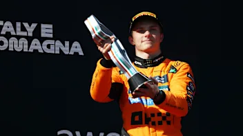 IMOLA, ITALY - MAY 18: Third placed Oscar Piastri of Australia and McLaren lifts his trophy on the