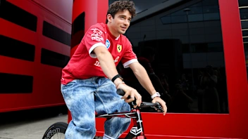 NORTHAMPTON, ENGLAND - JULY 03: Charles Leclerc of Monaco and Scuderia Ferrari on a bicycle during