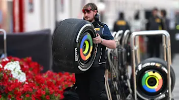 BAHRAIN, BAHRAIN - FEBRUARY 28: A team member of Pirelli carries a tyre in the Paddock during day