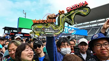 SUZUKA, JAPAN - MARCH 26: A fan holds a sign saying "Welcome to Suzuka" in the Pitlane during