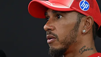 SINGAPORE, SINGAPORE - OCTOBER 08: Lewis Hamilton of Great Britain and Scuderia Ferrari talks to