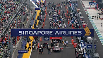 SINGAPORE, SINGAPORE - OCTOBER 10: The FIA Safety Car and drivers line up on the grid prior to the