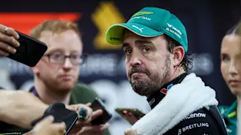 SINGAPORE, SINGAPORE - OCTOBER 10: Seventeenth placed qualifier Fernando Alonso of Spain and Aston