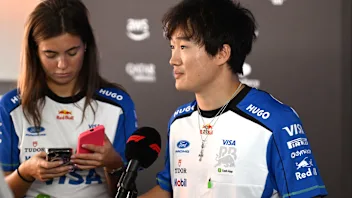 MONZA, ITALY - SEPTEMBER 03: Yuki Tsunoda of Japan and Visa Cash App Racing Bulls talks to the