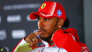 ZANDVOORT, NETHERLANDS - AUGUST 20: Lewis Hamilton of Great Britain and Scuderia Ferrari talks to