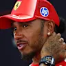 SINGAPORE, SINGAPORE - OCTOBER 08: Lewis Hamilton of Great Britain and Scuderia Ferrari talks to