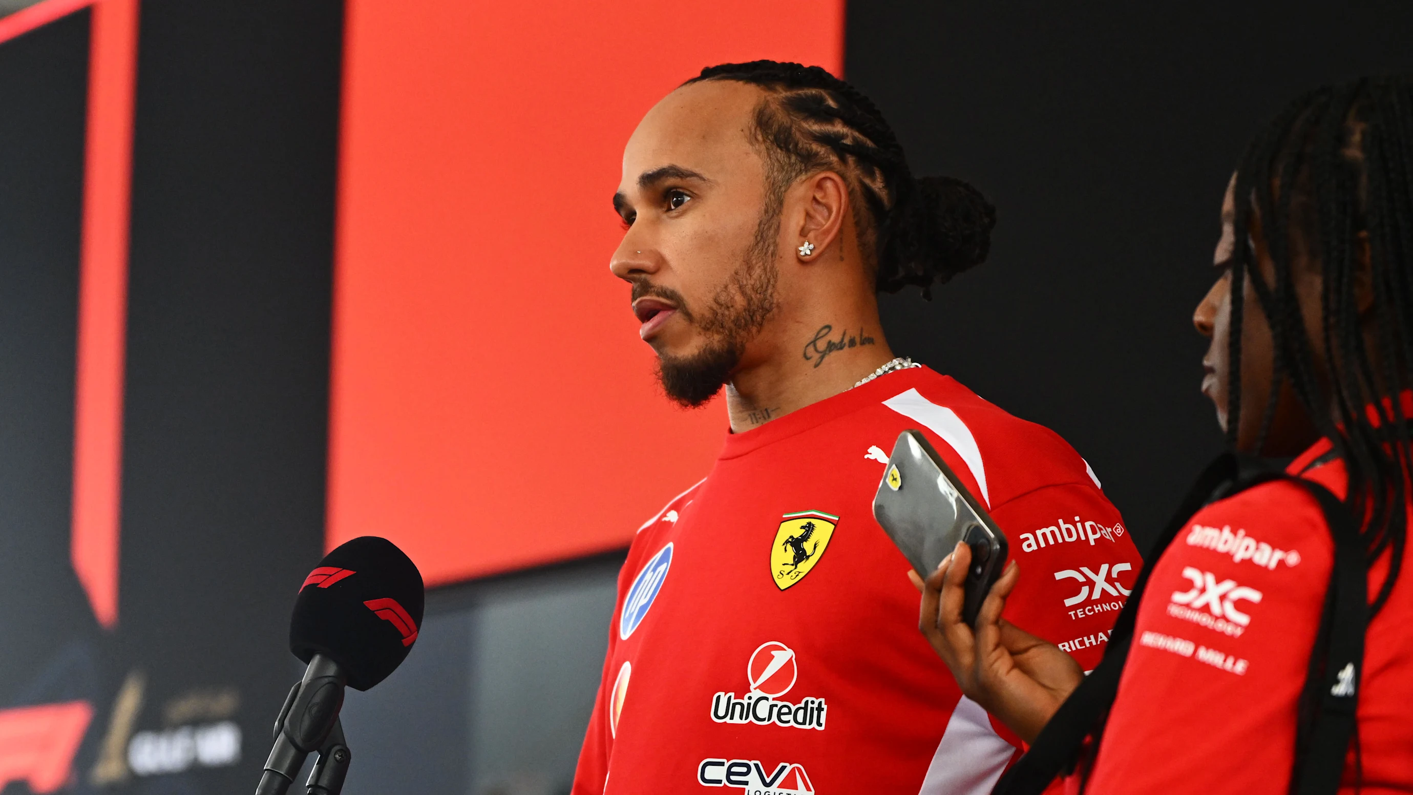 KUALA LUMPUR, MALAYSIA - OCTOBER 01: Lewis Hamilton of Great Britain and Scuderia Ferrari talks to