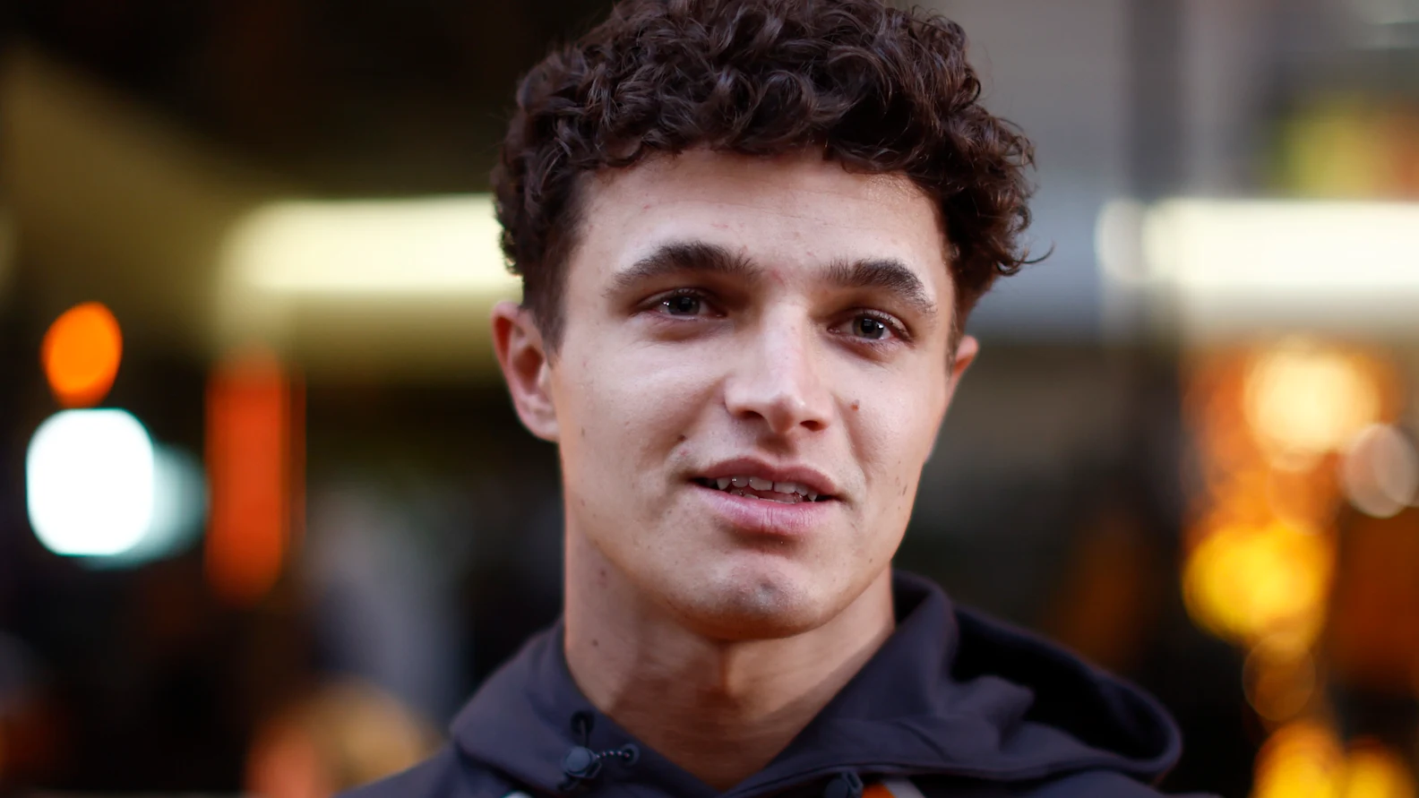 LUSAIL CITY, QATAR - NOVEMBER 27: Lando Norris of Great Britain and McLaren looks on in the Paddock during previews ahead of the F1 Grand Prix of Qatar at Lusail International Circuit on November 27, 2025 in Lusail City, Qatar. (Photo by Andrew Ferraro/LAT Images)