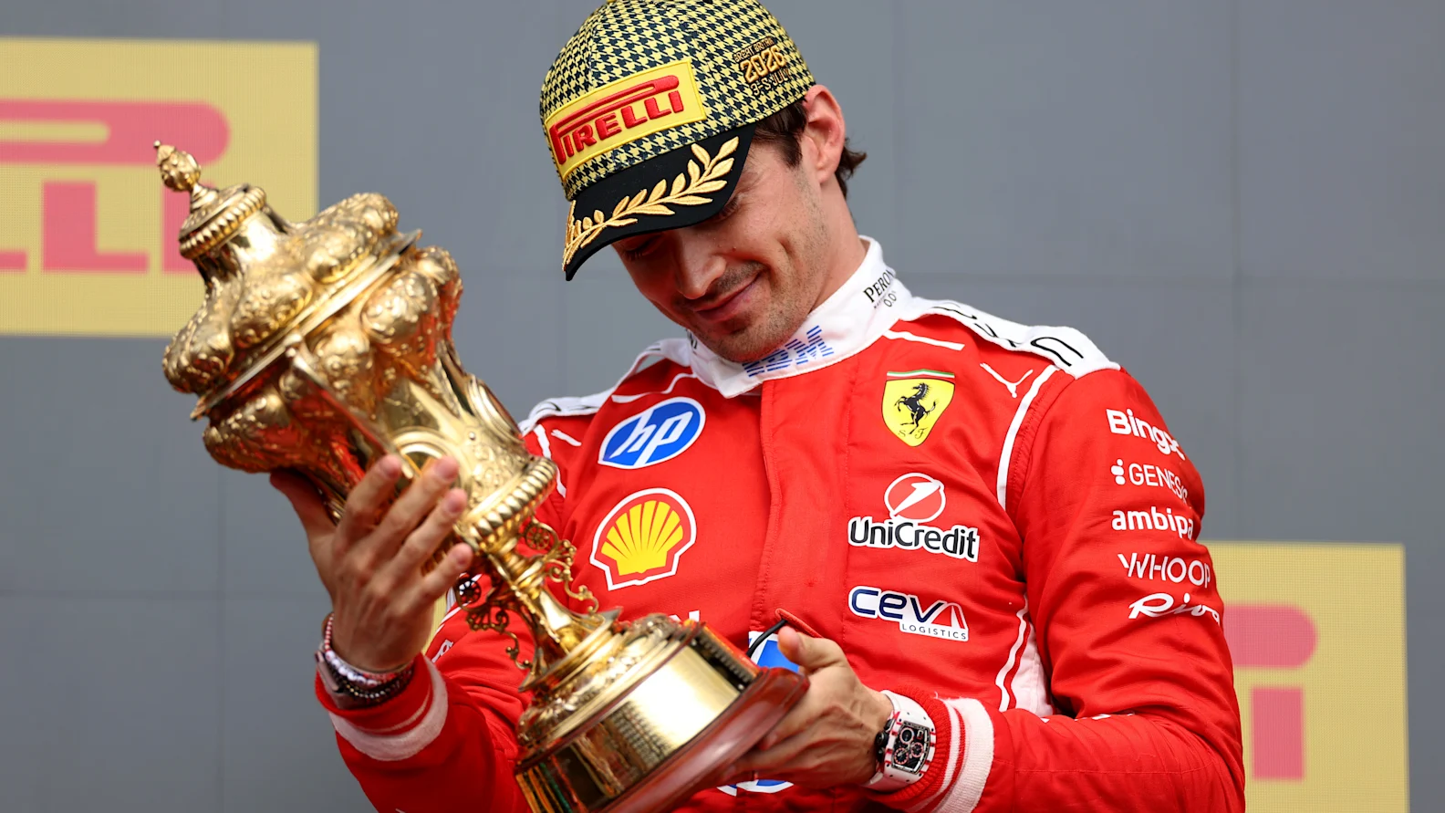 NORTHAMPTON, ENGLAND - JULY 05: Race winner Charles Leclerc of Monaco and Scuderia Ferrari on the podium with his trophy during the F1 Grand Prix of Great Britain at Silverstone Circuit on July 05, 2026 in Northampton, England. (Photo by Alastair Staley/LAT Images)
