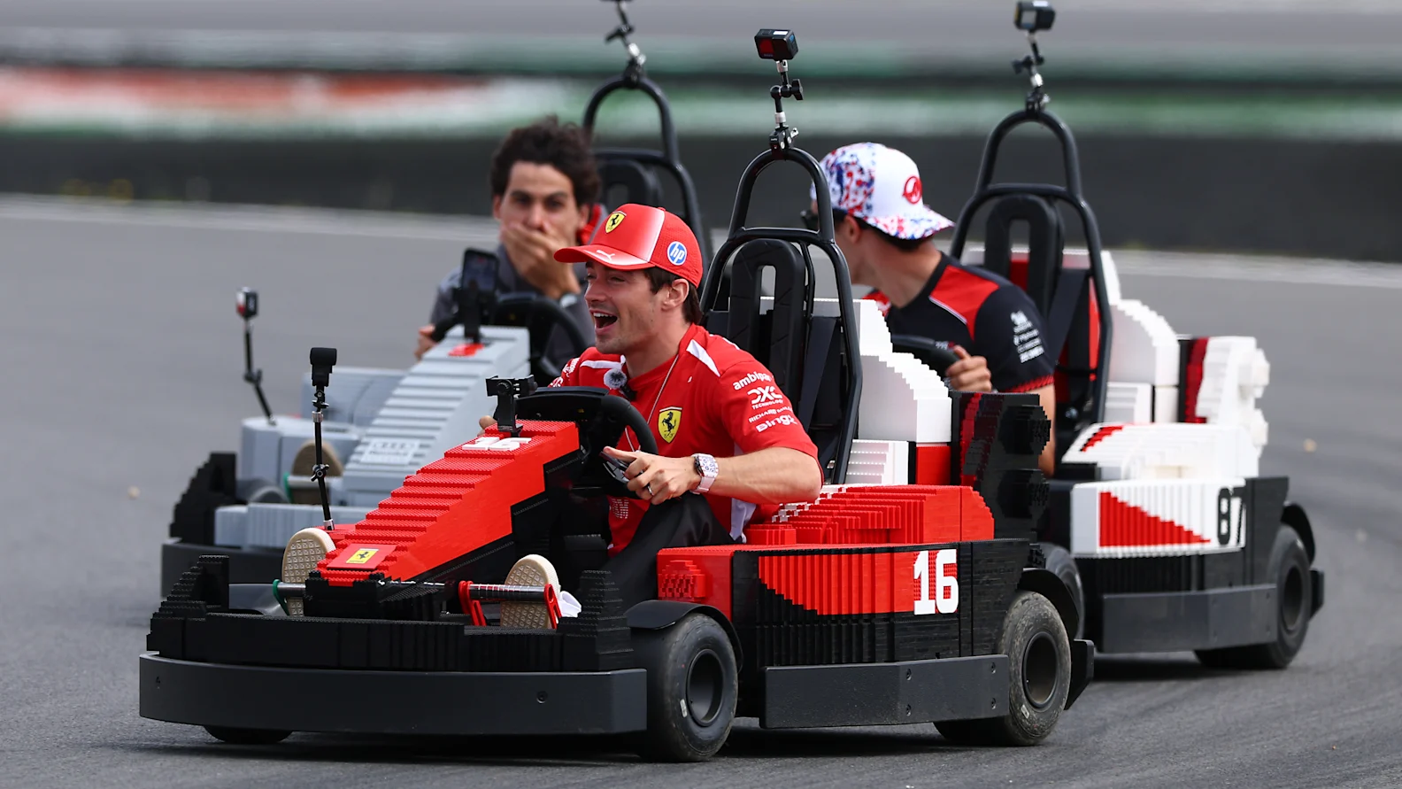 NORTHAMPTON, ENGLAND - JULY 05: Charles Leclerc of Monaco and Scuderia Ferrari Oliver Bearman of Great Britain and Haas F1 and Gabriel Bortoleto of Brazil and Audi F1 Team drive Lego Minicars on the drivers parade prior to the F1 Grand Prix of Great Britain at Silverstone Circuit on July 05, 2026 in Northampton, England. (Photo by Clive Mason/Getty Images)