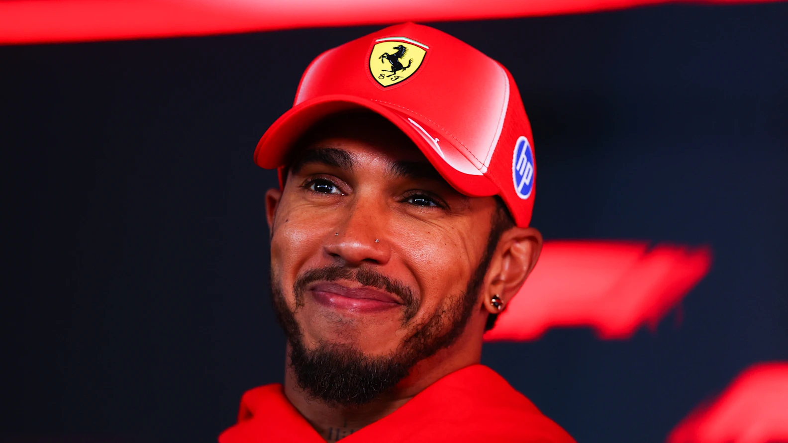 BUDAPEST, HUNGARY - JULY 23: Lewis Hamilton of Great Britain and Scuderia Ferrari talks to the