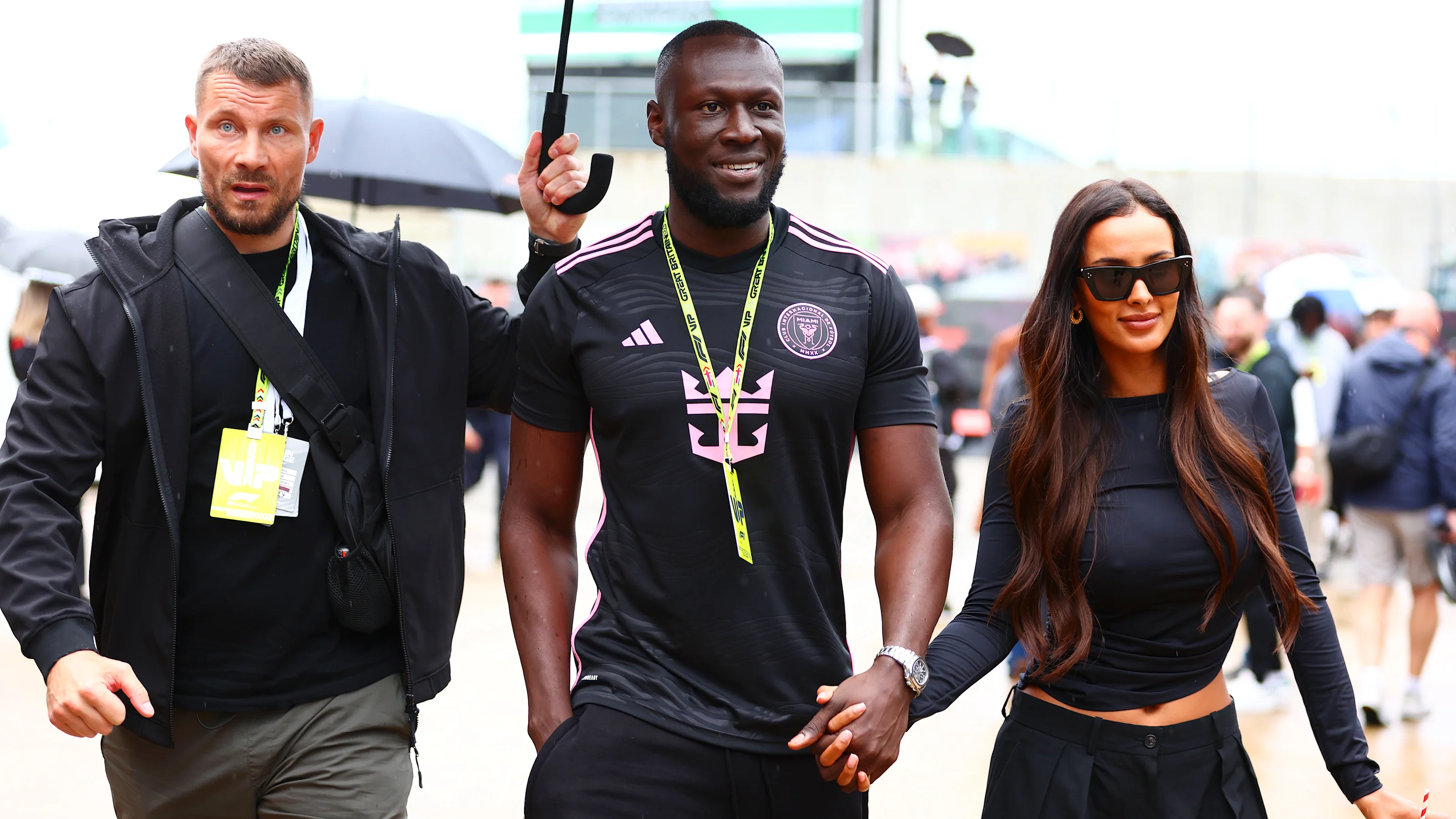 NORTHAMPTON, ENGLAND - JULY 05: Stormzy and Maya Jama walk in the Paddock after practice ahead of