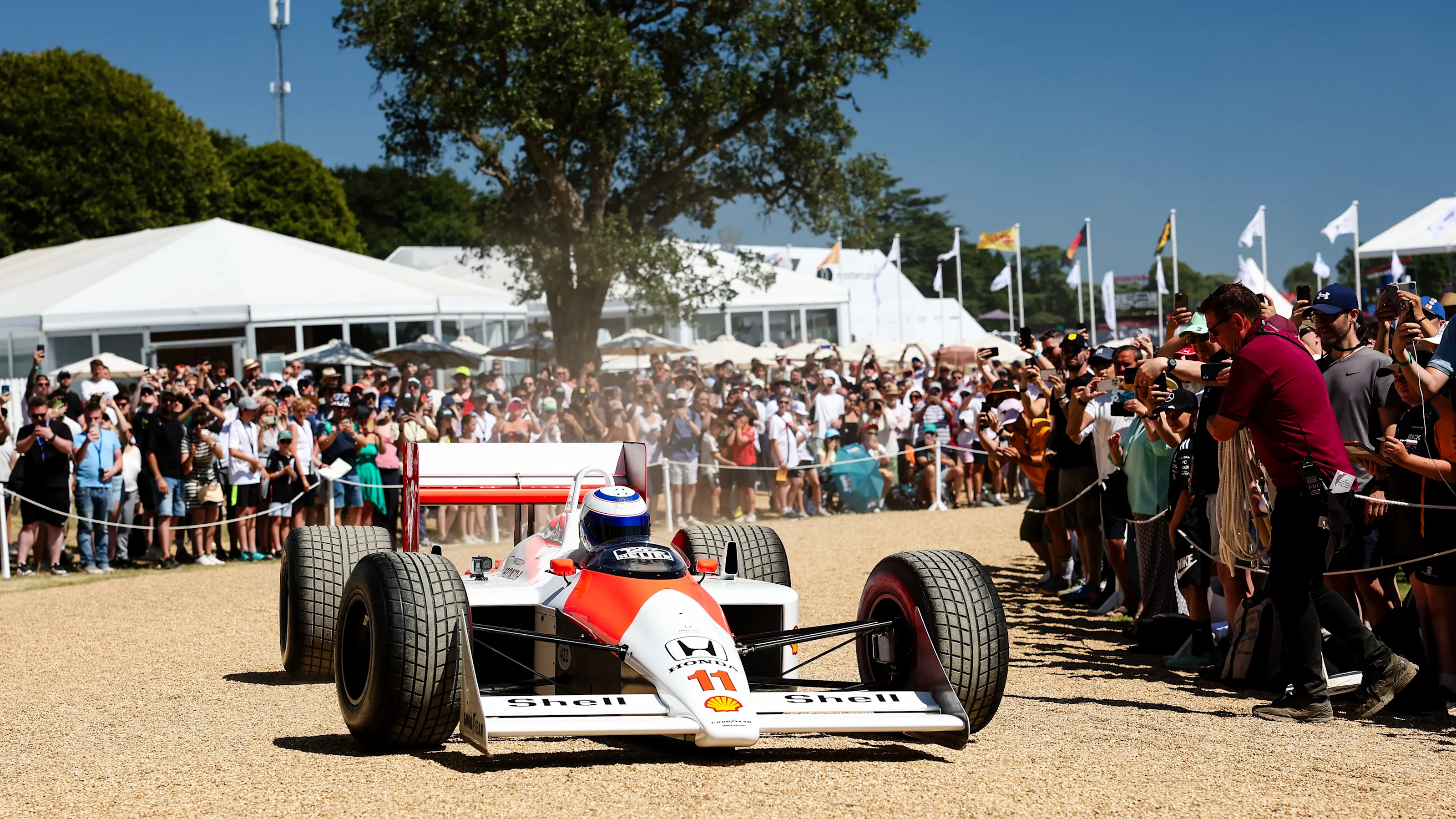 CHICHESTER, ENGLAND - JULY 13: Alain Prost / McLaren during his balcony moment at the Goodwood