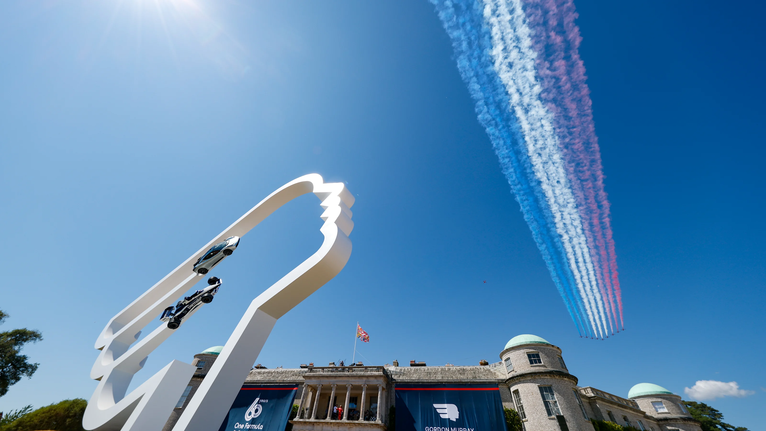 CHICHESTER, ENGLAND - JULY 13: An air display flies over the venue during the Goodwood Festival of