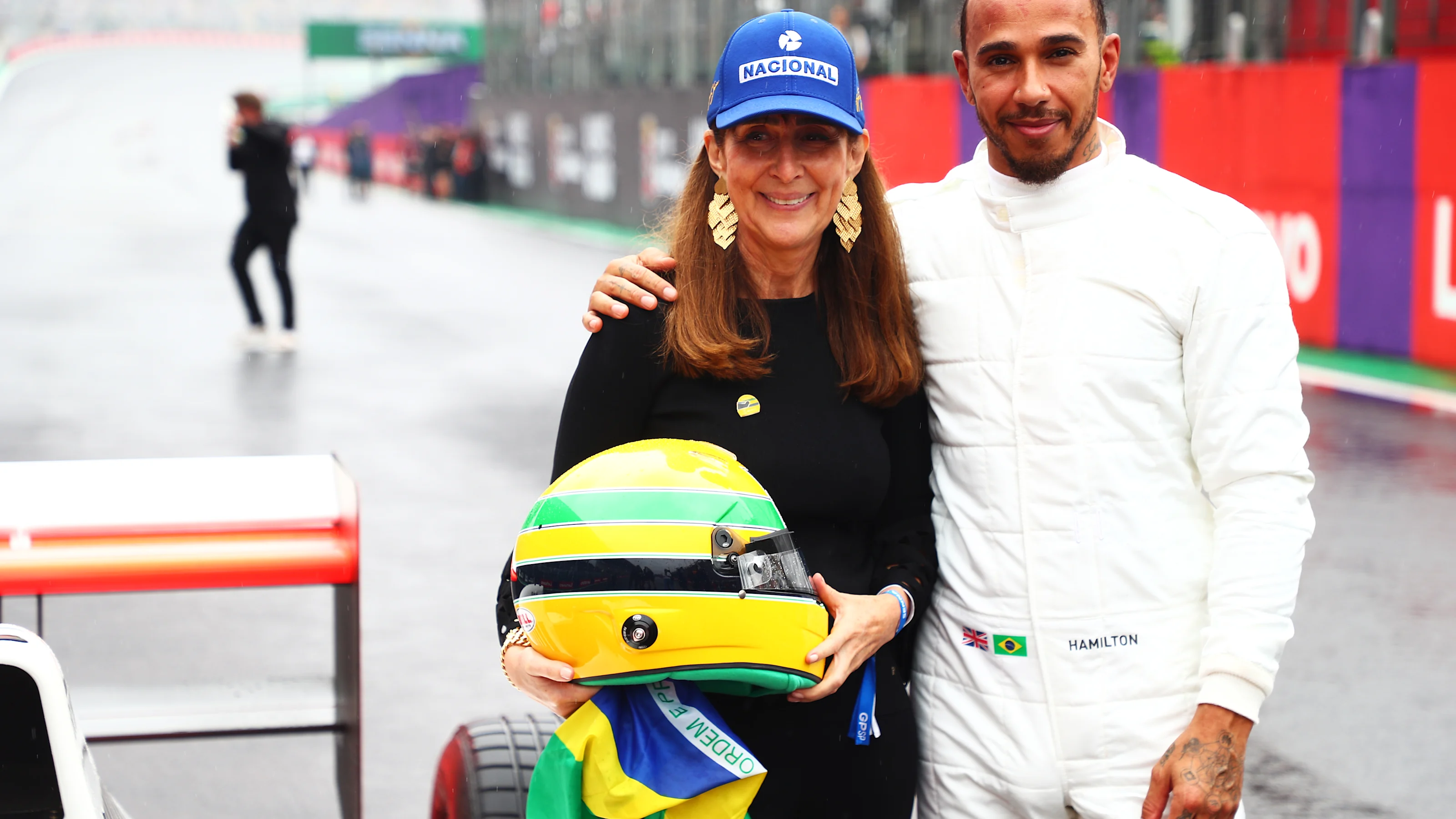 SAO PAULO, BRAZIL - NOVEMBER 03: Lewis Hamilton of Great Britain and Mercedes greets Viviane Senna