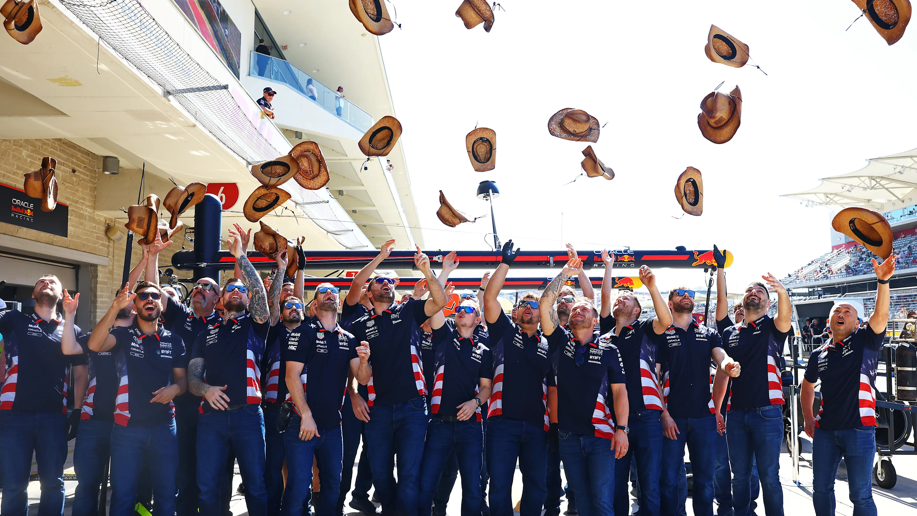 AUSTIN, TEXAS - OCTOBER 20: The Oracle Red Bull Racing team throw their cowboy hats in the air