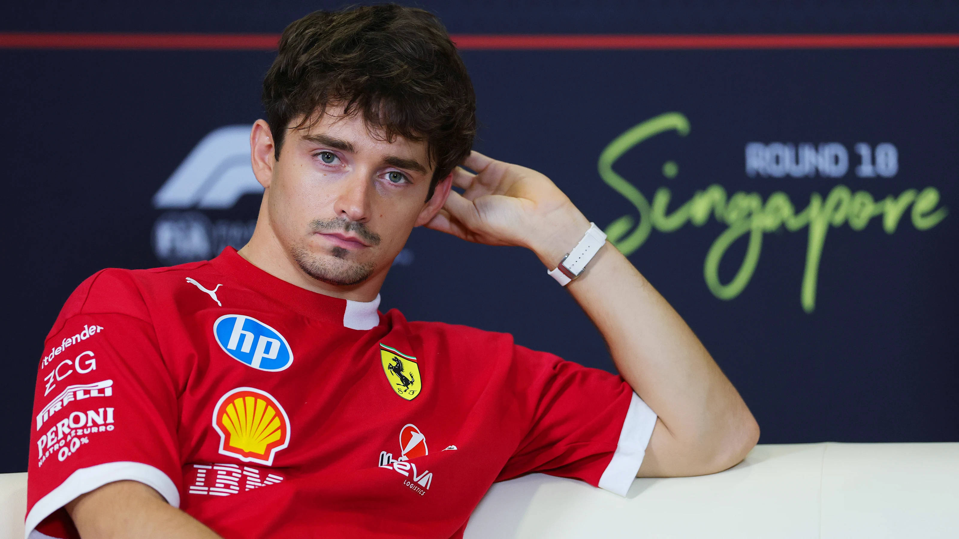 SINGAPORE, SINGAPORE - OCTOBER 02: Charles Leclerc of Monaco and Scuderia Ferrari looks on in the