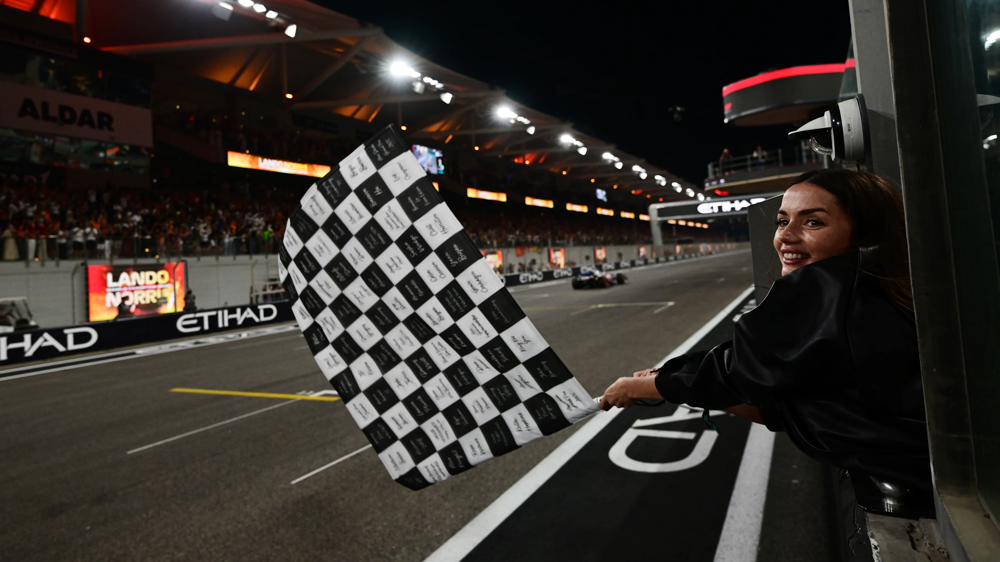 ABU DHABI, UNITED ARAB EMIRATES - DECEMBER 07: Ana de Armas waves the chequered flag during the F1