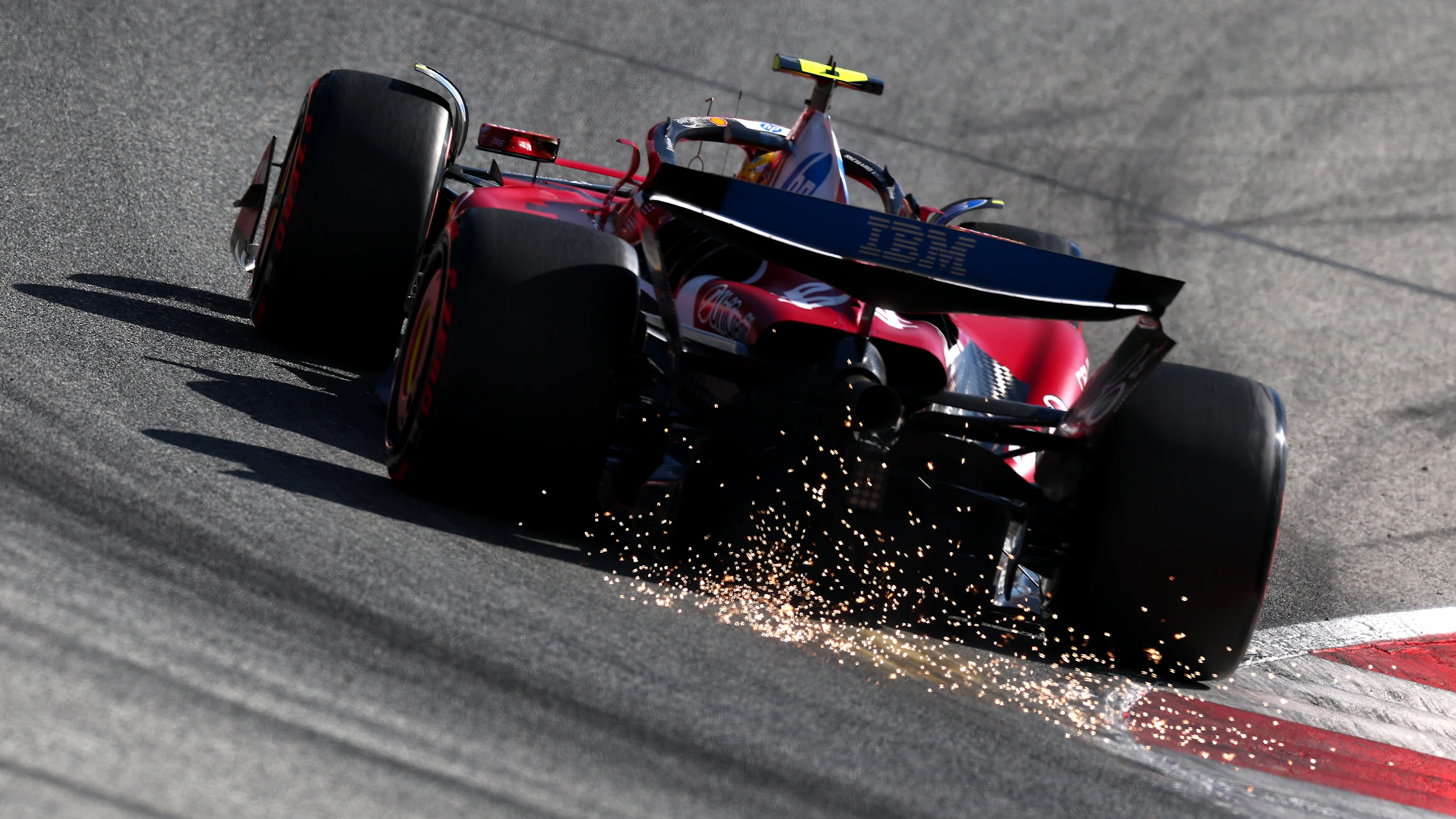 SPIELBERG, AUSTRIA - JUNE 28: Sparks fly behind Lewis Hamilton of Great Britain driving the (44)