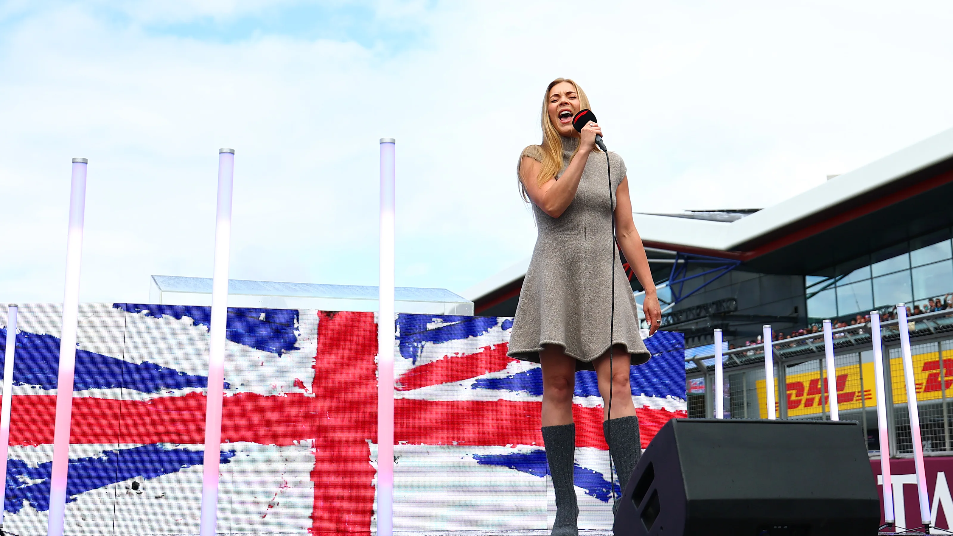 NORTHAMPTON, ENGLAND - JULY 06: Becky Hill performs the national anthem on the grid during the F1