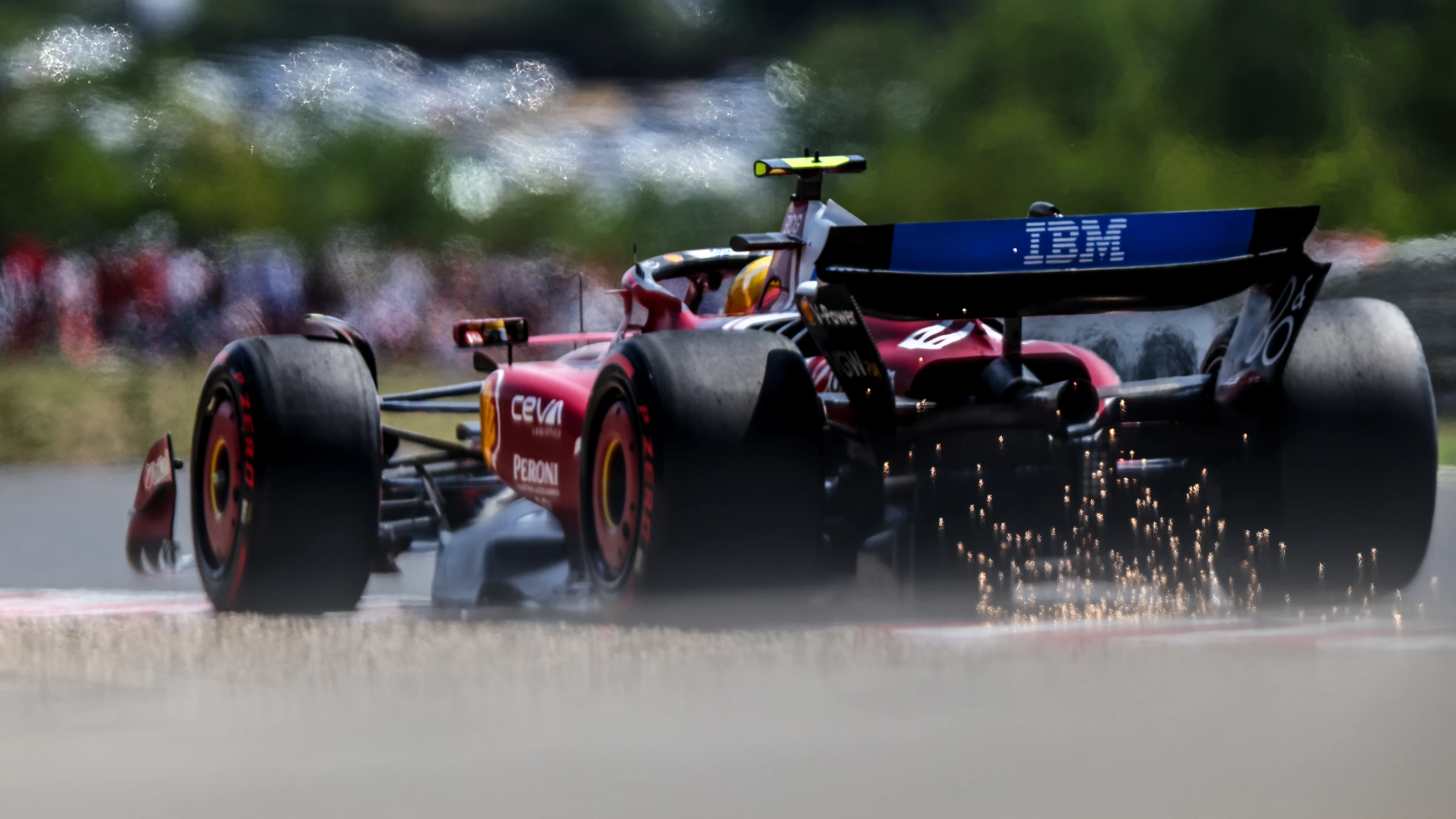 BUDAPEST, HUNGARY - AUGUST 02: Sparks fly behind Lewis Hamilton of Great Britain driving the (44)