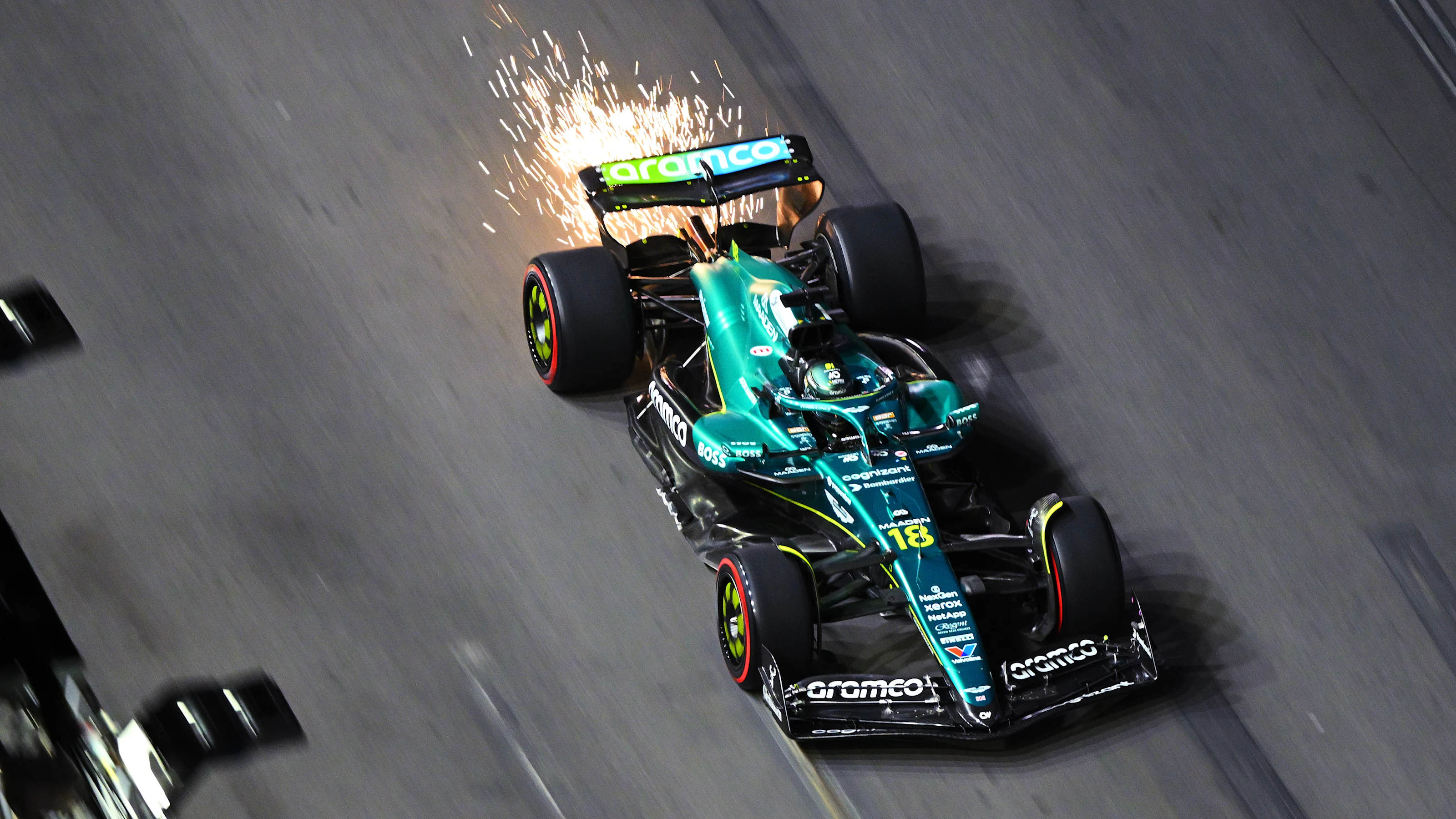 LAS VEGAS, NEVADA - NOVEMBER 20: Sparks fly behind Lance Stroll of Canada driving the (18) Aston