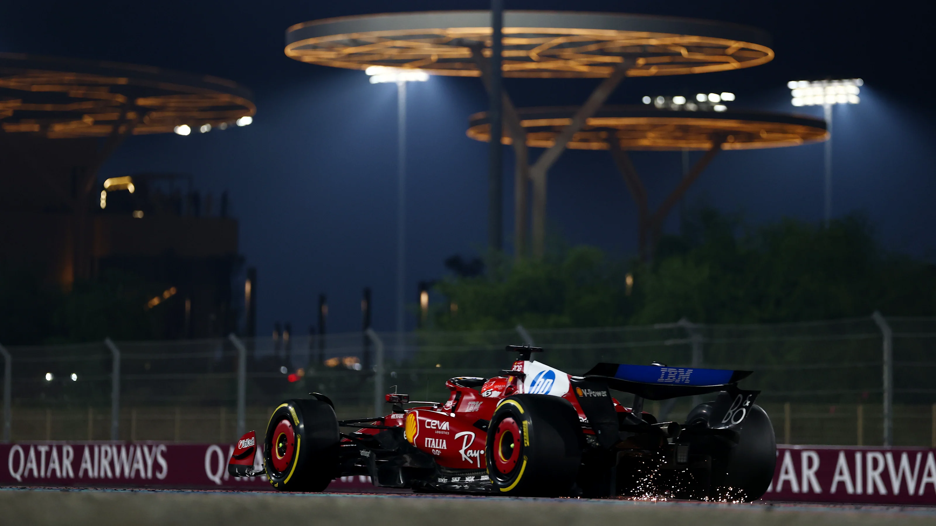 LUSAIL CITY, QATAR - NOVEMBER 30: Sparks fly behind Charles Leclerc of Monaco driving the (16)