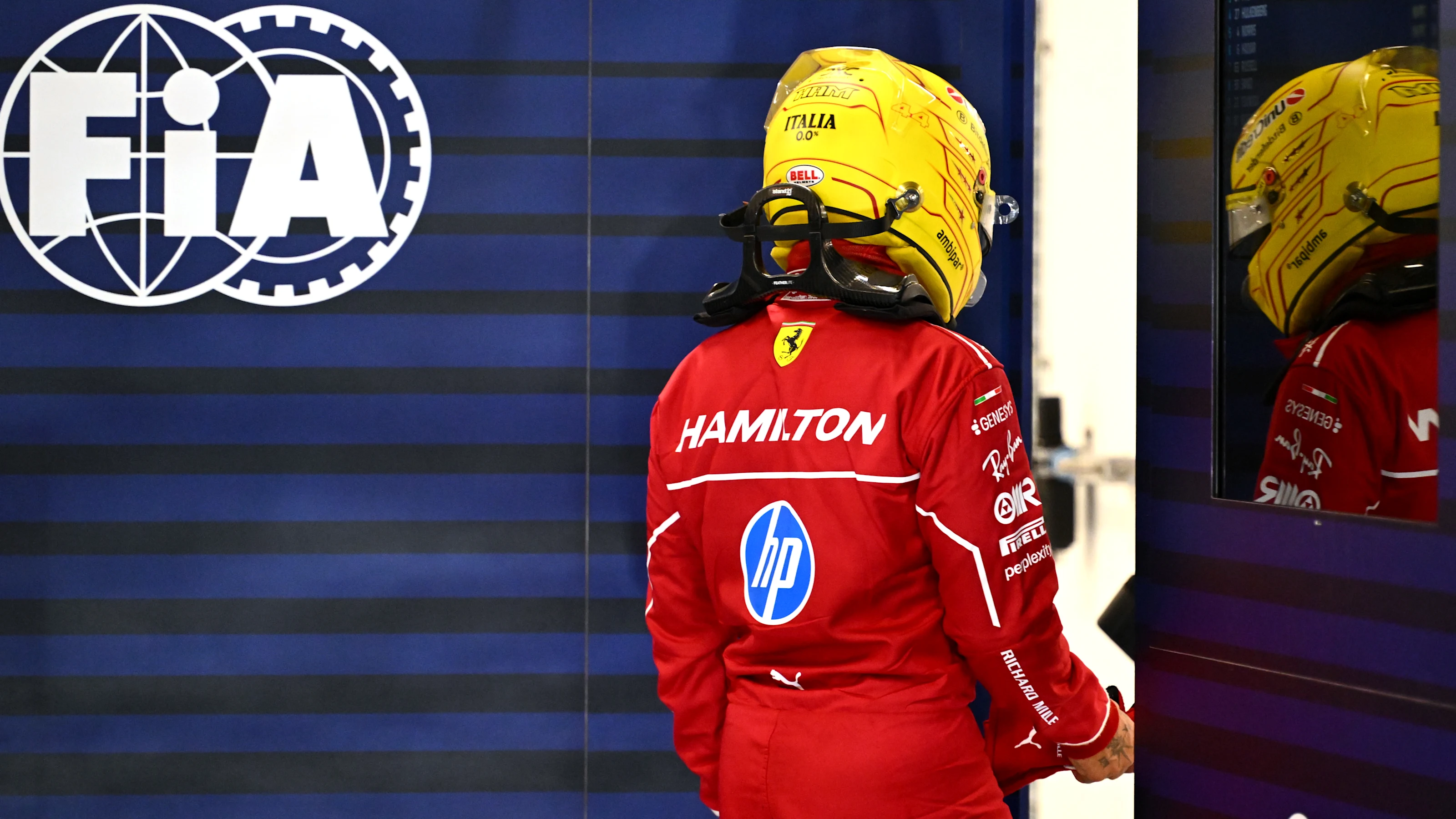 LUSAIL CITY, QATAR - NOVEMBER 28: Lewis Hamilton of Great Britain and Scuderia Ferrari looks on