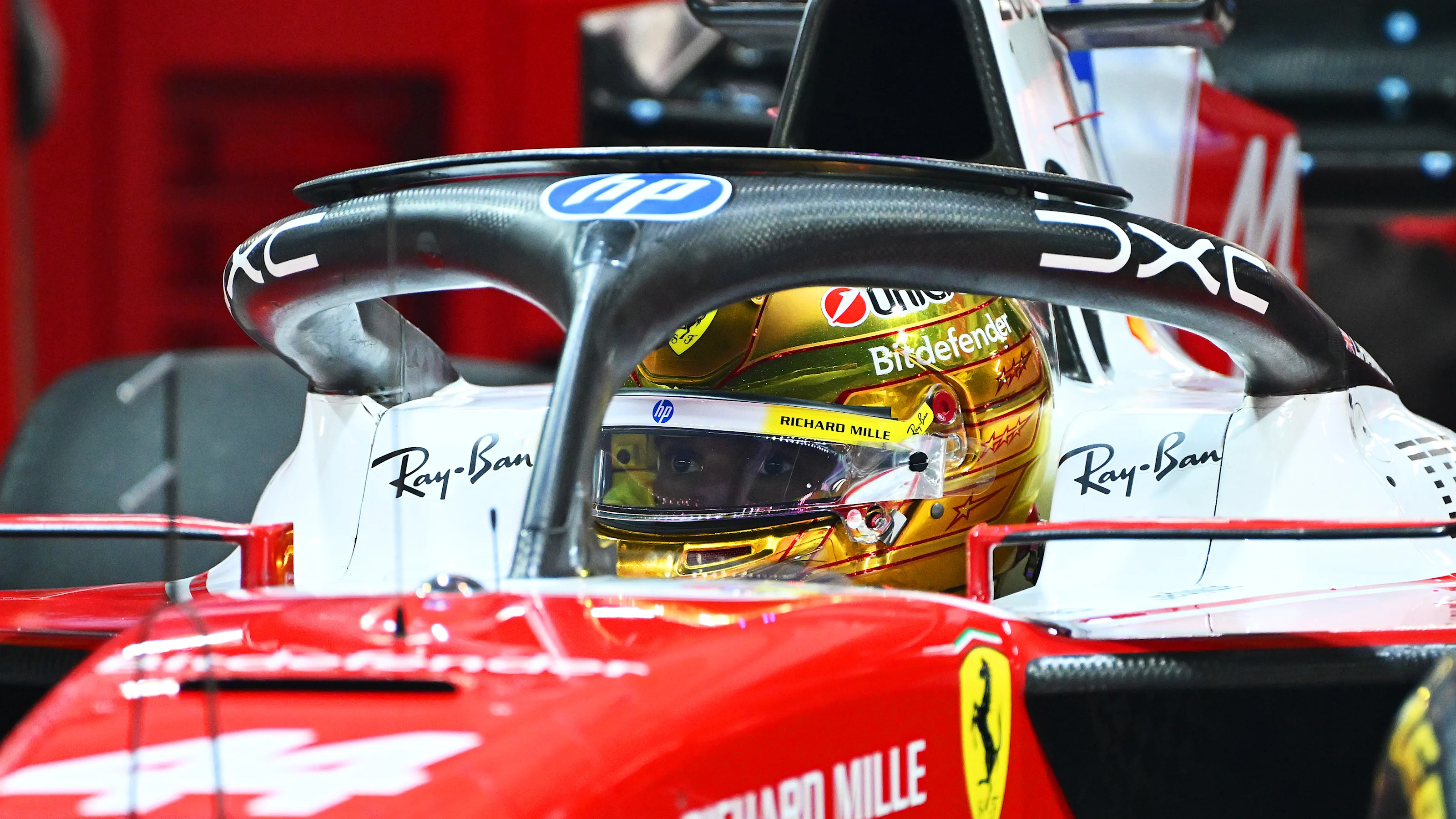 SINGAPORE, SINGAPORE - OCTOBER 09: Lewis Hamilton of Great Britain and Scuderia Ferrari prepares to