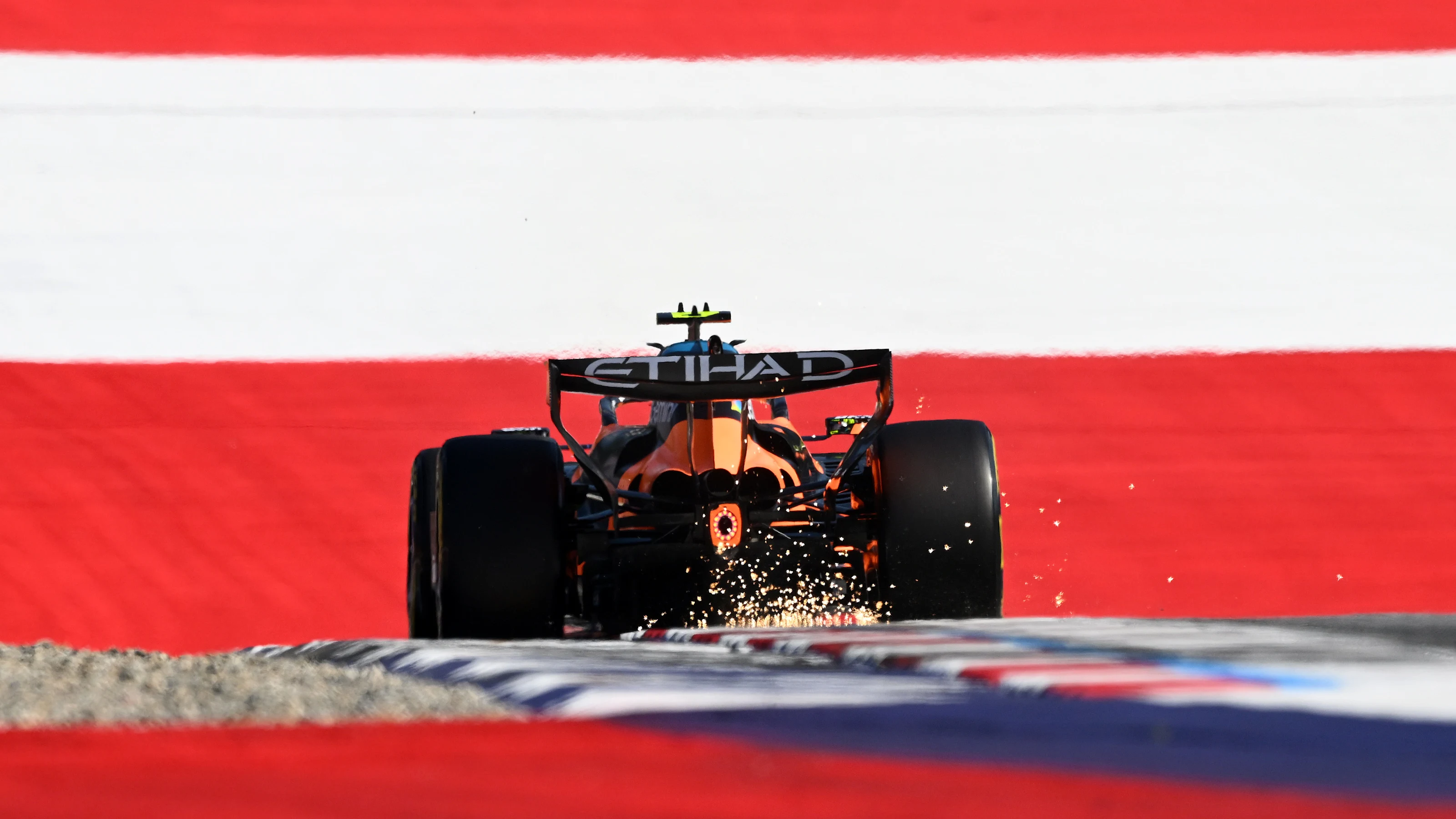 SPIELBERG, AUSTRIA - JUNE 26: Sparks fly behind Lando Norris of Great Britain driving the (1)