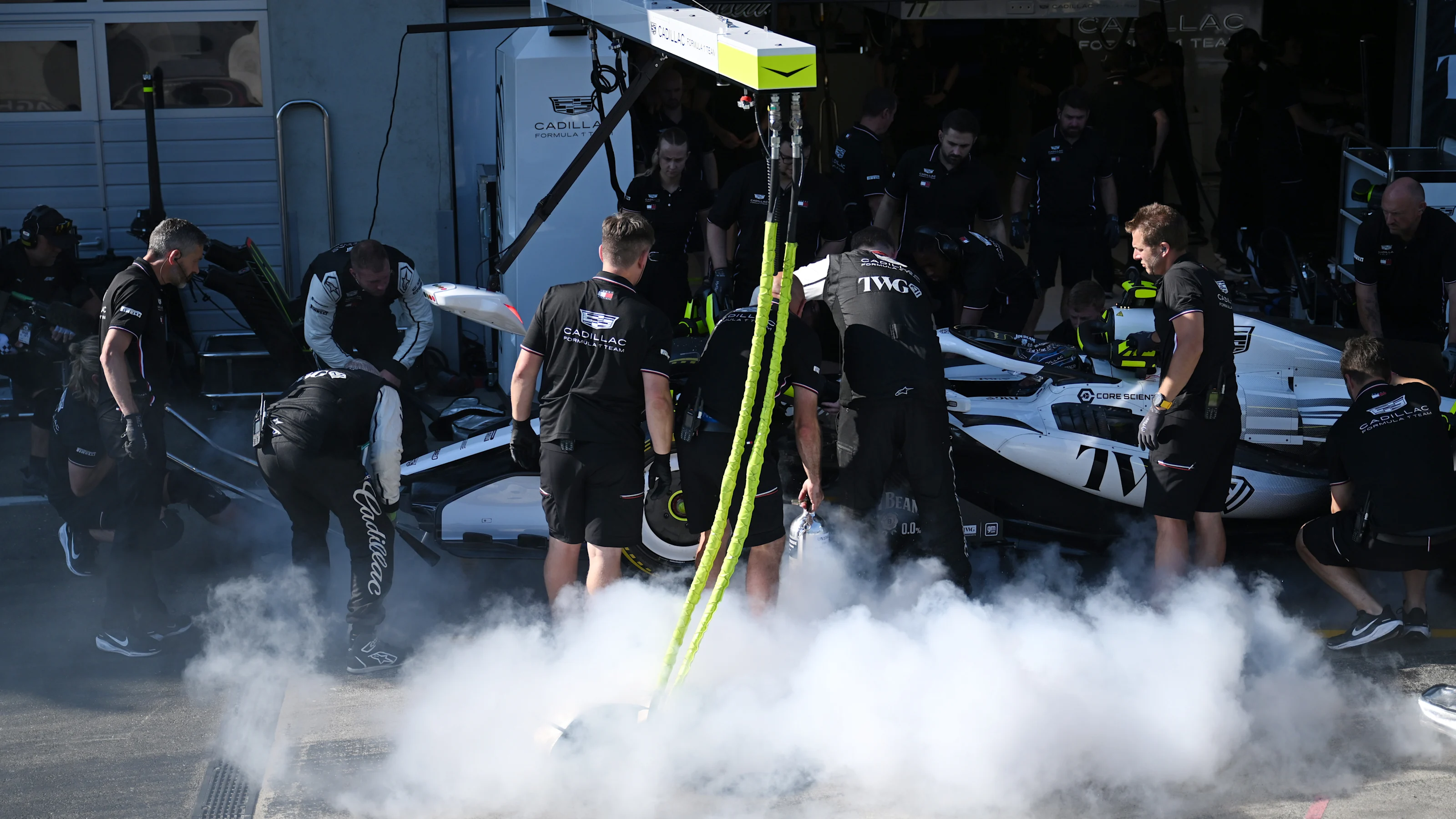 SPIELBERG, AUSTRIA - JUNE 26: Cadillac F1 Team personnel extinguish a fire on the car of Sergio