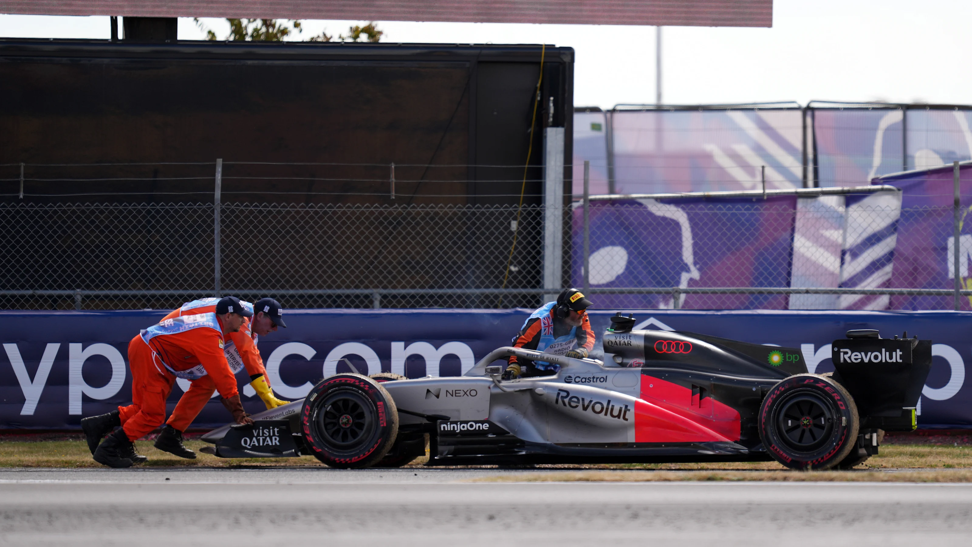 NORTHAMPTON, ENGLAND - JULY 05: Marshals recover the car of Nico Hulkenberg of Germany and Audi F1