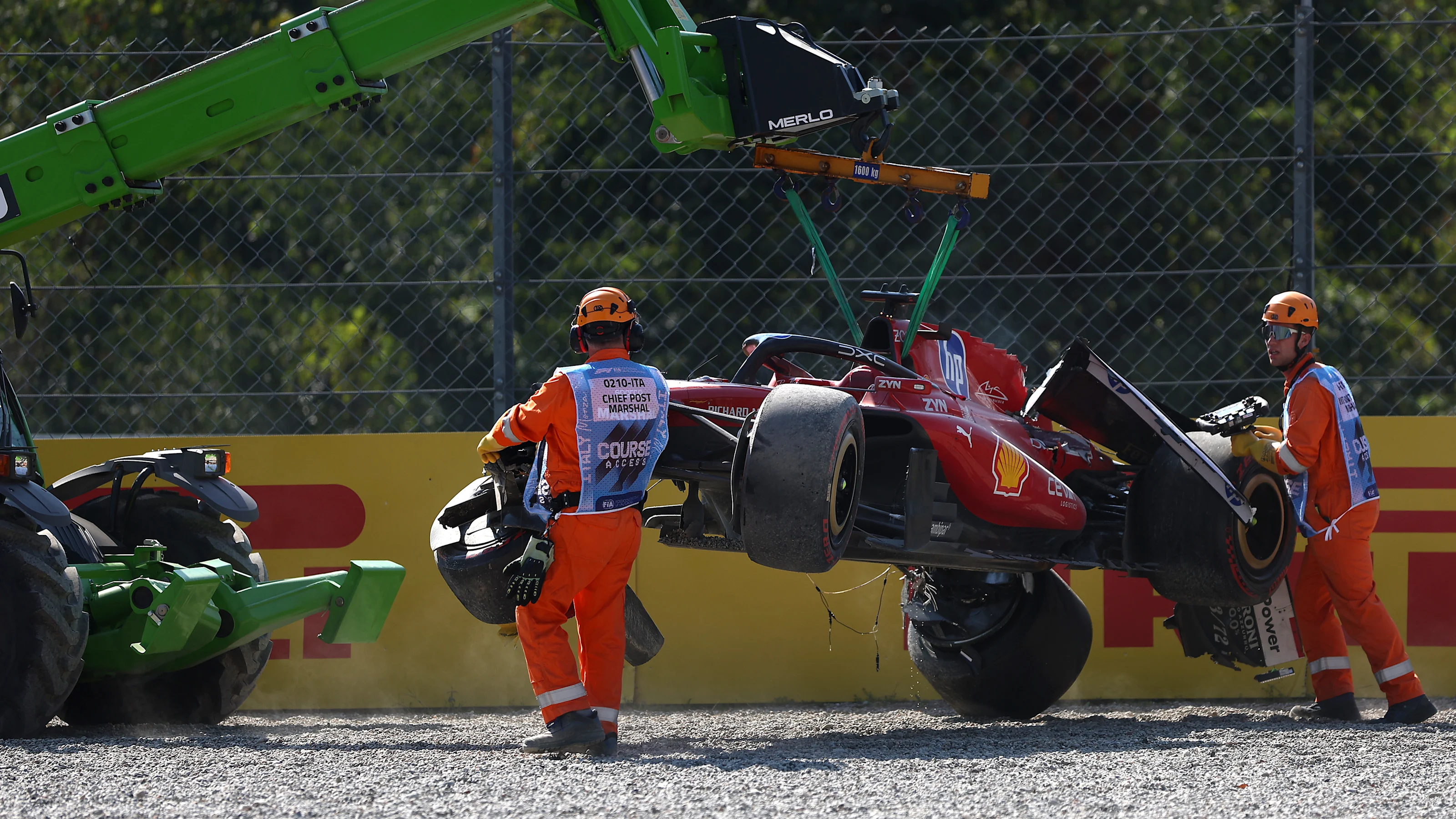 MONZA, ITALY - SEPTEMBER 06: Marshals remove the damaged car of Charles Leclerc of Monaco and