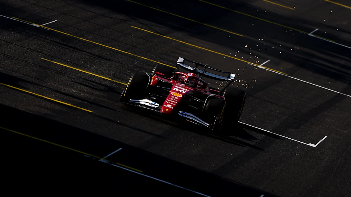 Charles Leclerc drives the Ferrari SF-25 at Interlagos with sparks flying behind the car.