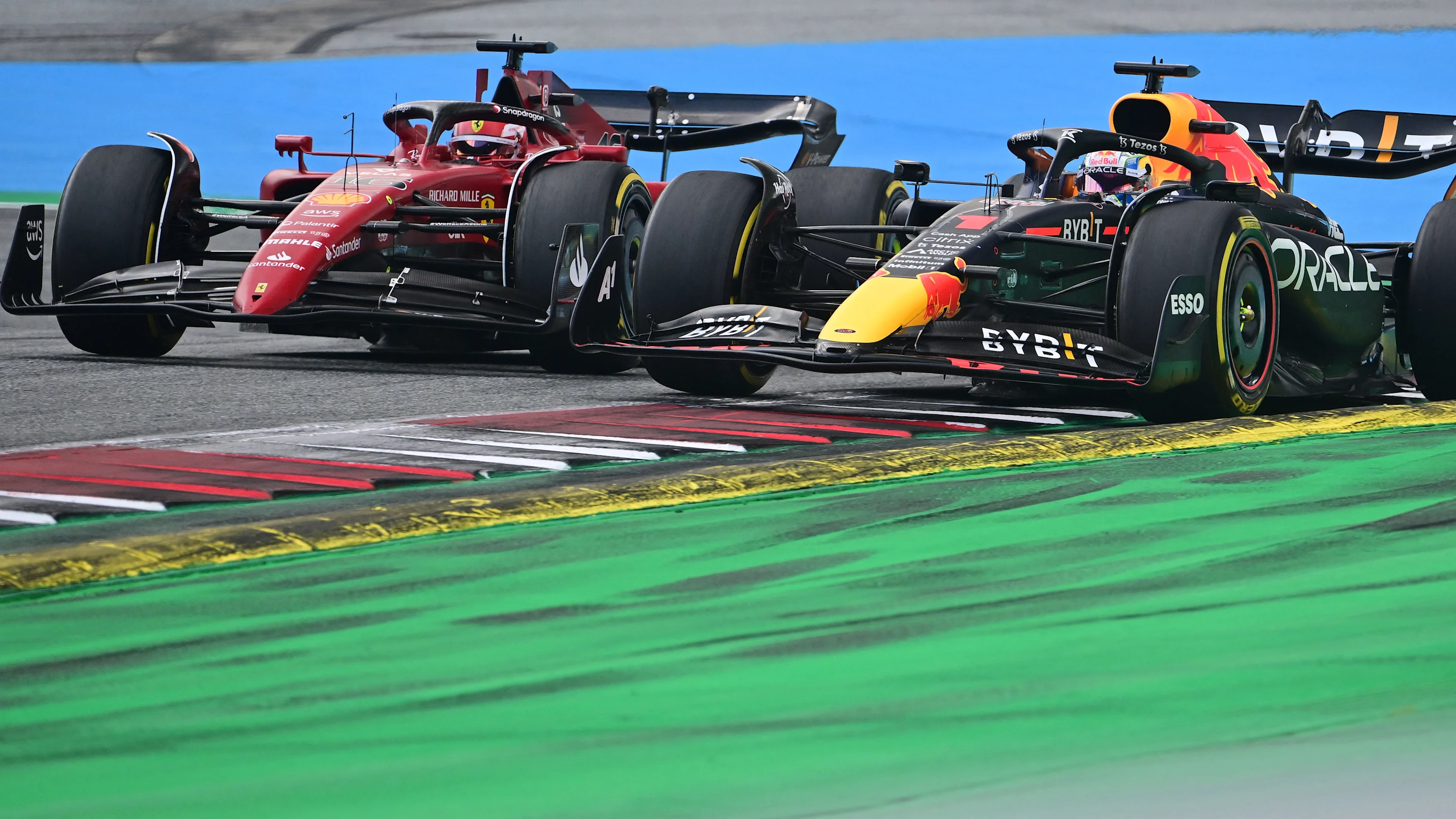 Ferrari's Monegasque driver Charles Leclerc (L) competes to win ahead of Red Bull Racing's Dutch