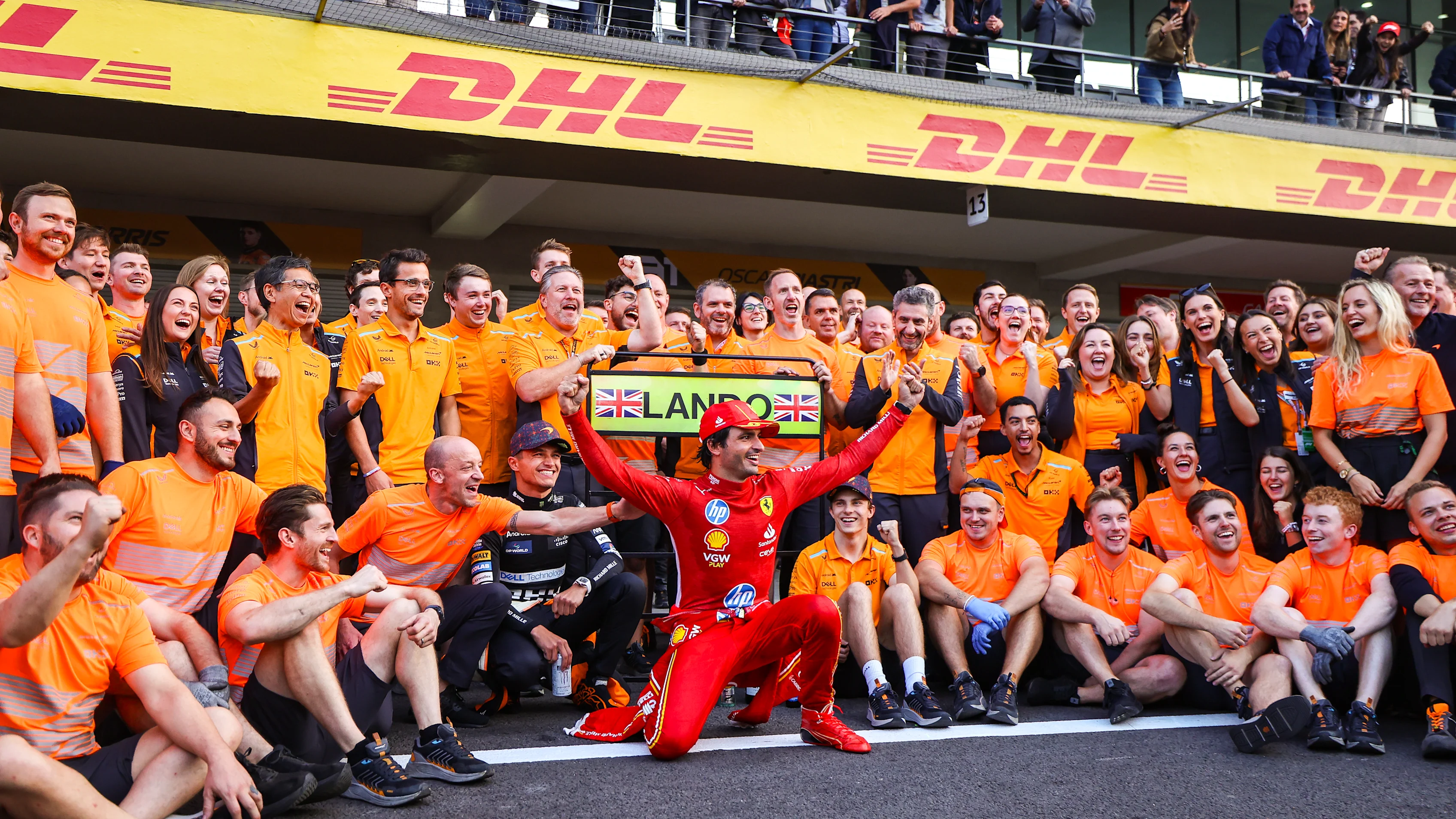 MEXICO CITY, MEXICO - OCTOBER 27: Carlos Sainz of Spain and Ferrari photobombs the McLaren
