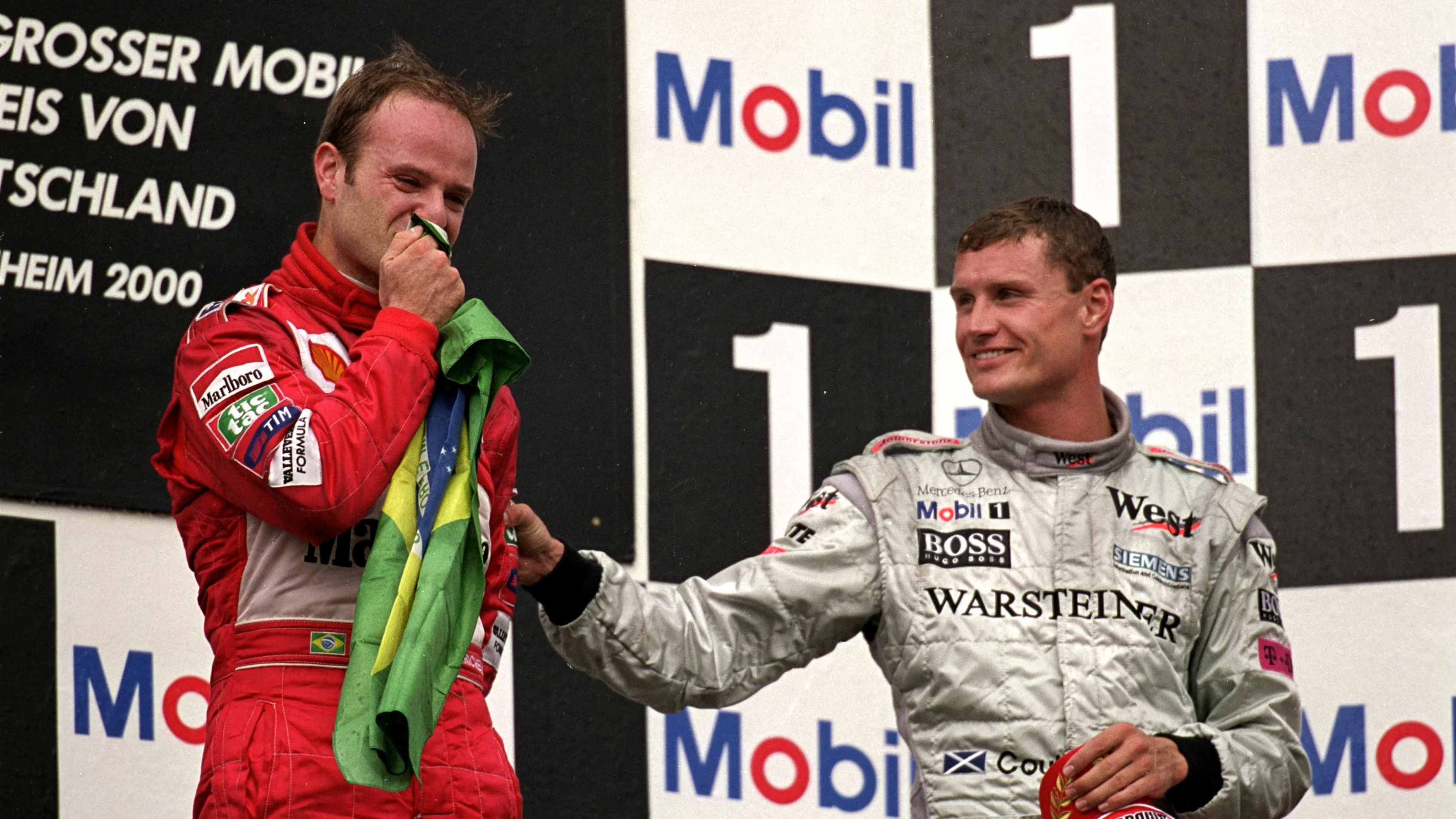 30 Jul 2000: Rubens Barrichello of Brazil and Ferrari kisses the Brazilian flag after winning the