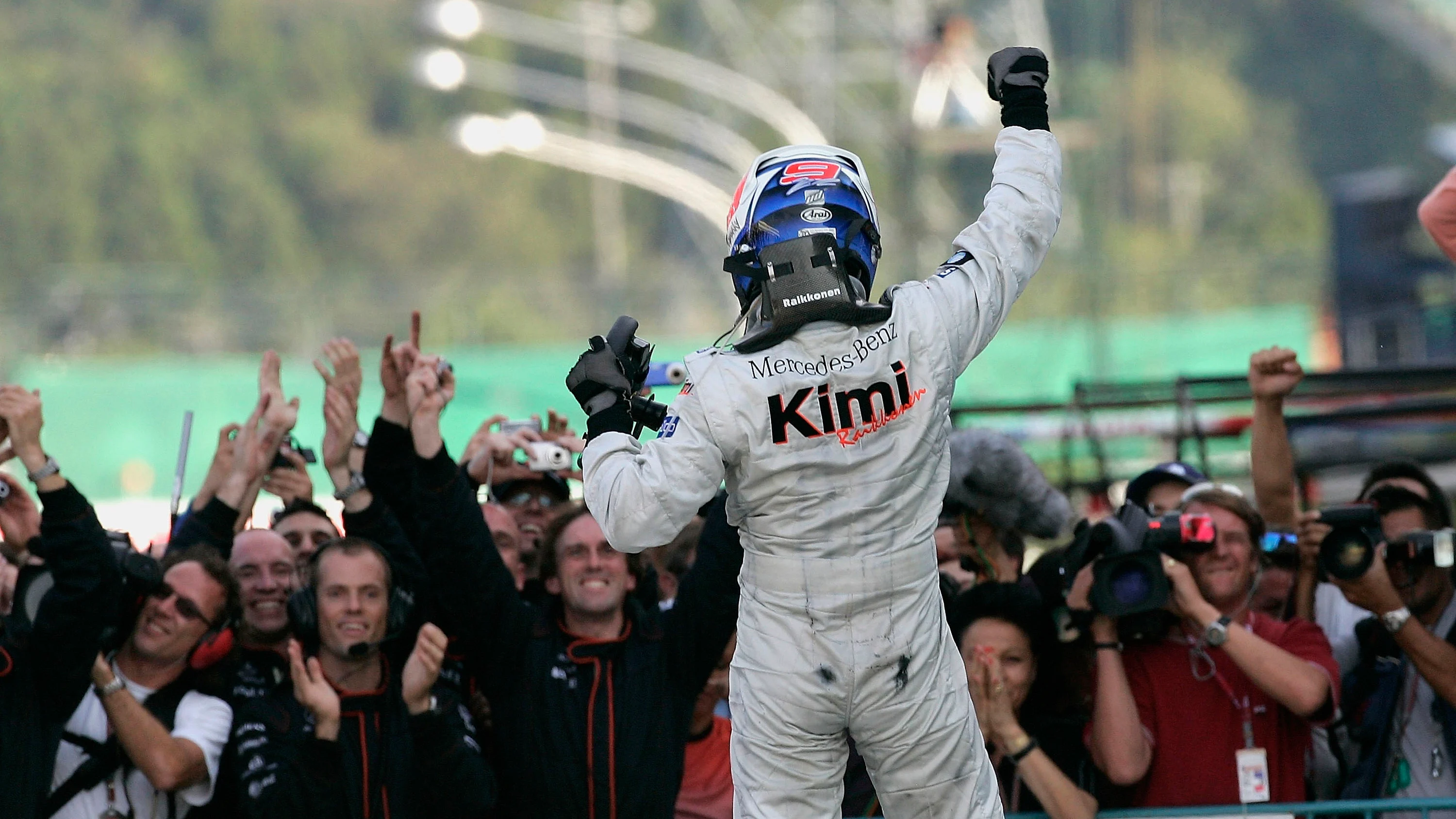 SUZUKA, JAPAN - OCTOBER 09: Kimi Raikkonen of Finland and McLaren celebrates after victory in the
